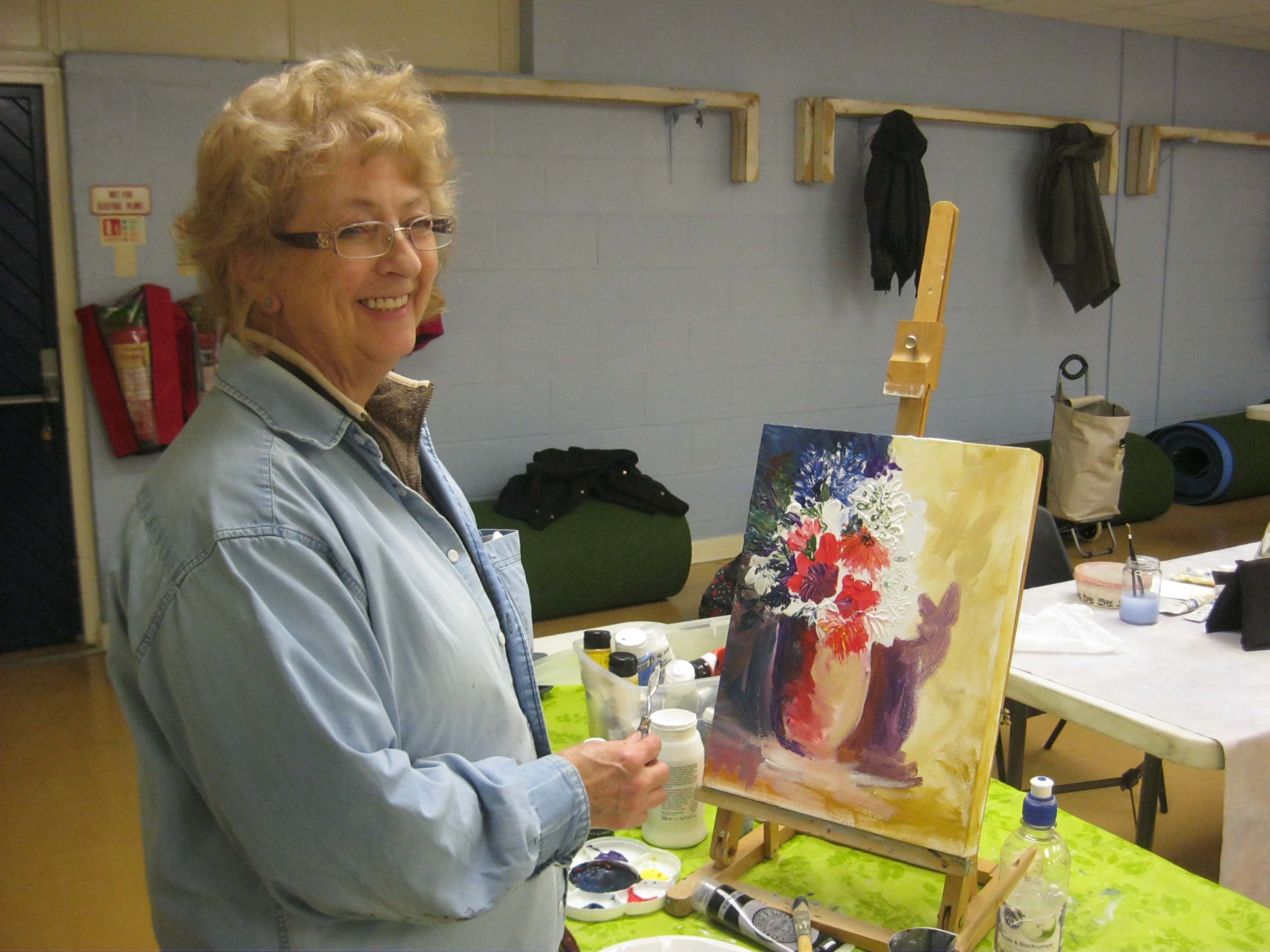 sefton art group member working with palette knife