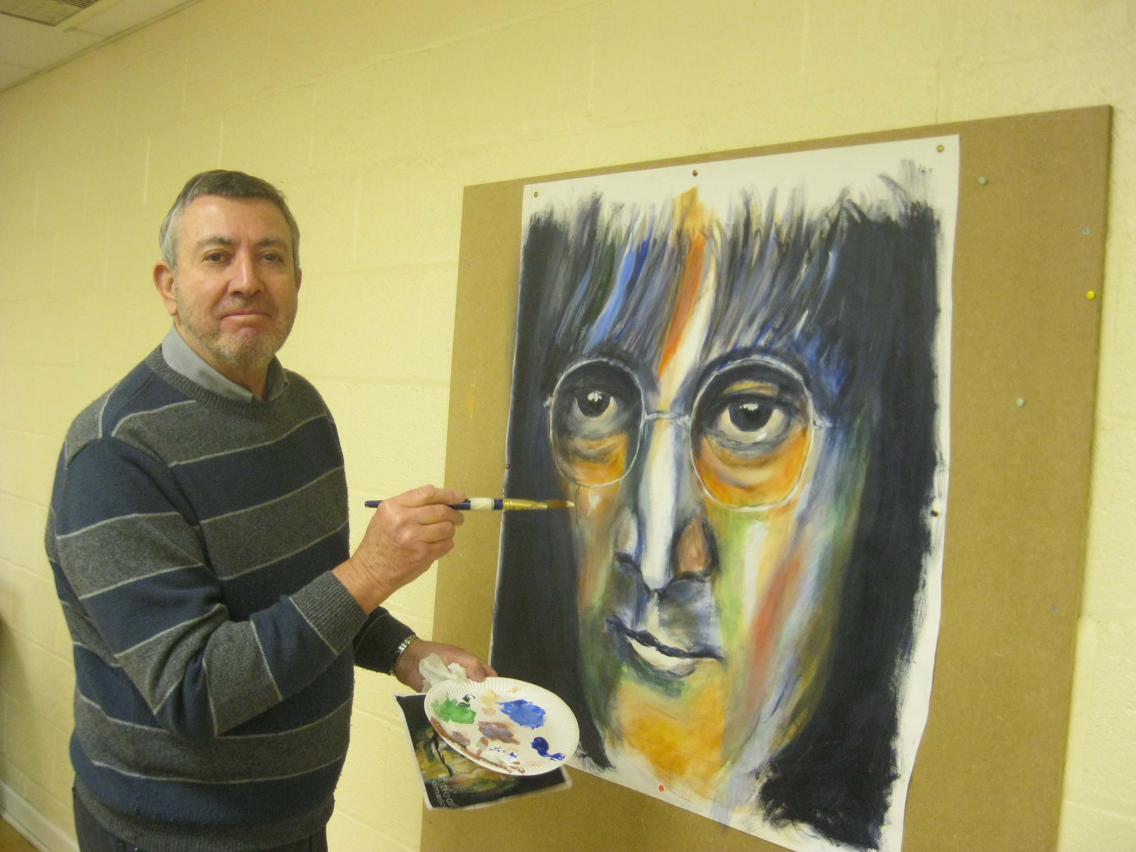 sefton art group artist frank working on a big picture